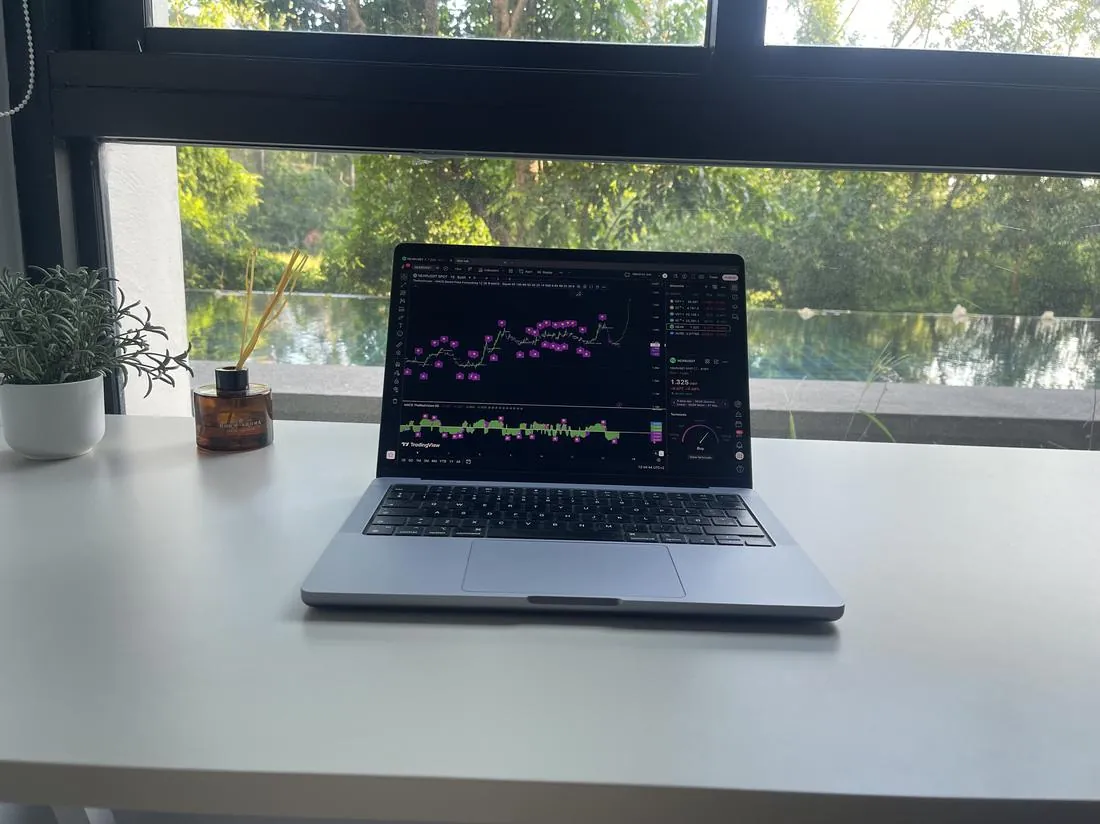 Laptop with trading charts by the pool